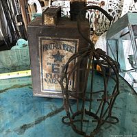 Front view of varnish tin showing label and trouble light cage