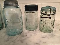 Three jars front view showing embossing and lids
