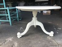 side view showing oval top and tripod base