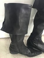 Full view of boot showing fold-down cuff, leather texture and inner ankle zipper