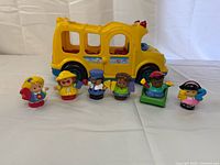 Bus with all six figures lined up in front