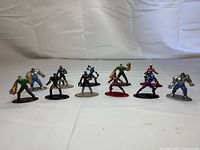 Front view of all eleven die-cast Marvel figures on bases