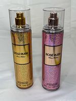 Front view of both fragrance mists showing labels and colors