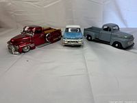 Three die-cast pickup models side by side