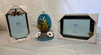 Group shot of two picture frames and hummingbird feeder