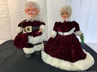 Full view of both Claus figures standing side by side