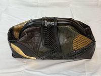 Front view of patchwork leather clutch showing textures and colors