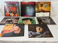 Group shot of all eight LP fronts showing artists and partial titles