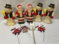 Front view of all items: five blow molds and four picks