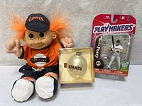 Lot overview showing troll doll, boxed ornament, sealed Posey figure