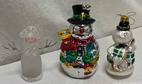 Group shot of three snowman figurines