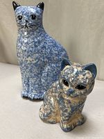 Front view of both ceramic cats