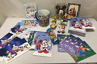 Overview of cards, mug and figurines spread out on table