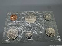 Six-coin proof-like set in original sealed cellophane, reverse designs visible