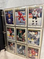 Open binder page showing nine cards including Dale Hawerchuk, Wayne Gretzky