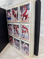 Binder page showing nine Upper Deck 1991-92 hockey cards in sleeves