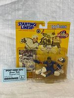 Front of sealed 1998 Starting Lineup Grant Fuhr figure showing autograph and included mask, card, and autograph ticket