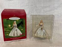 Ornament in clear insert beside original red Hallmark box