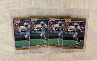 Front view of four Barry Sanders 1989 Pro Set rookie cards in toploaders