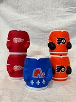 Front view of five foam hockey jersey koozies stacked and grouped