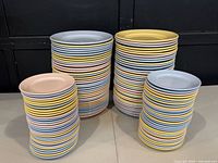 Four stacks of pastel glazed plates showing quantity and colour mix
