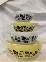 Stacked view of all four Gooseberry Cinderella bowls showing alternating yellow and white colors and black pattern