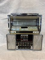 Front view showing entire Seeburg SC1 consolette with keypad and speakers