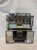 Front view showing full Seeburg Consolette SC1 jukebox with speakers, buttons, coin slot
