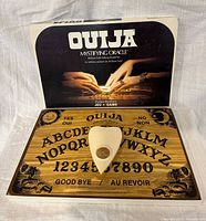 Box lid open showing board and planchette