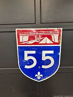 Front view of Quebec Autoroute 55 sign showing full graphics and wear