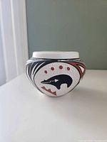 Front view showing stylized animal motif and rim