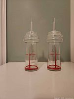 Front view showing both glasses, graphics, and lids