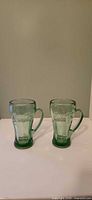 Both green Libbey Coca-Cola glasses front view