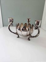 Front view showing lotus bowl and three candle sconces