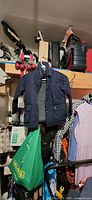 Front view of navy quilted jacket hanging