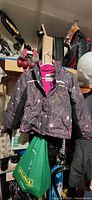 Front view of gray multicolor OshKosh kids jacket size 7 hanging