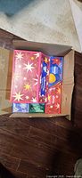 Open carton showing multiple Kleenex Holiday Design Hand Towels boxes