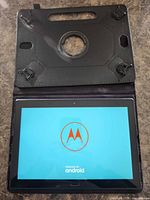 Tablet in open folio case displaying Motorola boot logo