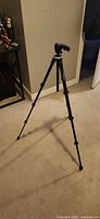 Full view of tripod standing with legs extended