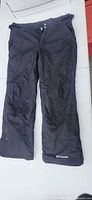Full view of front of black Columbia snow pants