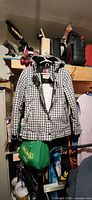 Full view of plaid snowboard jacket hanging