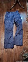 Full view of navy blue Reebok snow pants front side