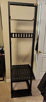 Full view of open-frame rack with vented shelf, flat shelf and patch panel installed