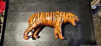 Left side view of carved wood tiger figurine