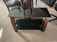 Front view showing three glass shelves and wooden side panels