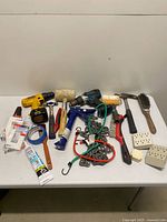 Full lot overview showing drills, hand tools, chain, adapters and consumables