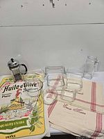 Entire lot showing glass containers, bowls, pitcher, French press and three towels