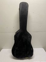 Front view of closed black hard shell guitar case