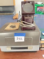 Anscomatic II projector with Airequipt viewer, manual and cords visible