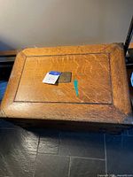 Top view of oak steamer trunk showing wood grain and inset panel